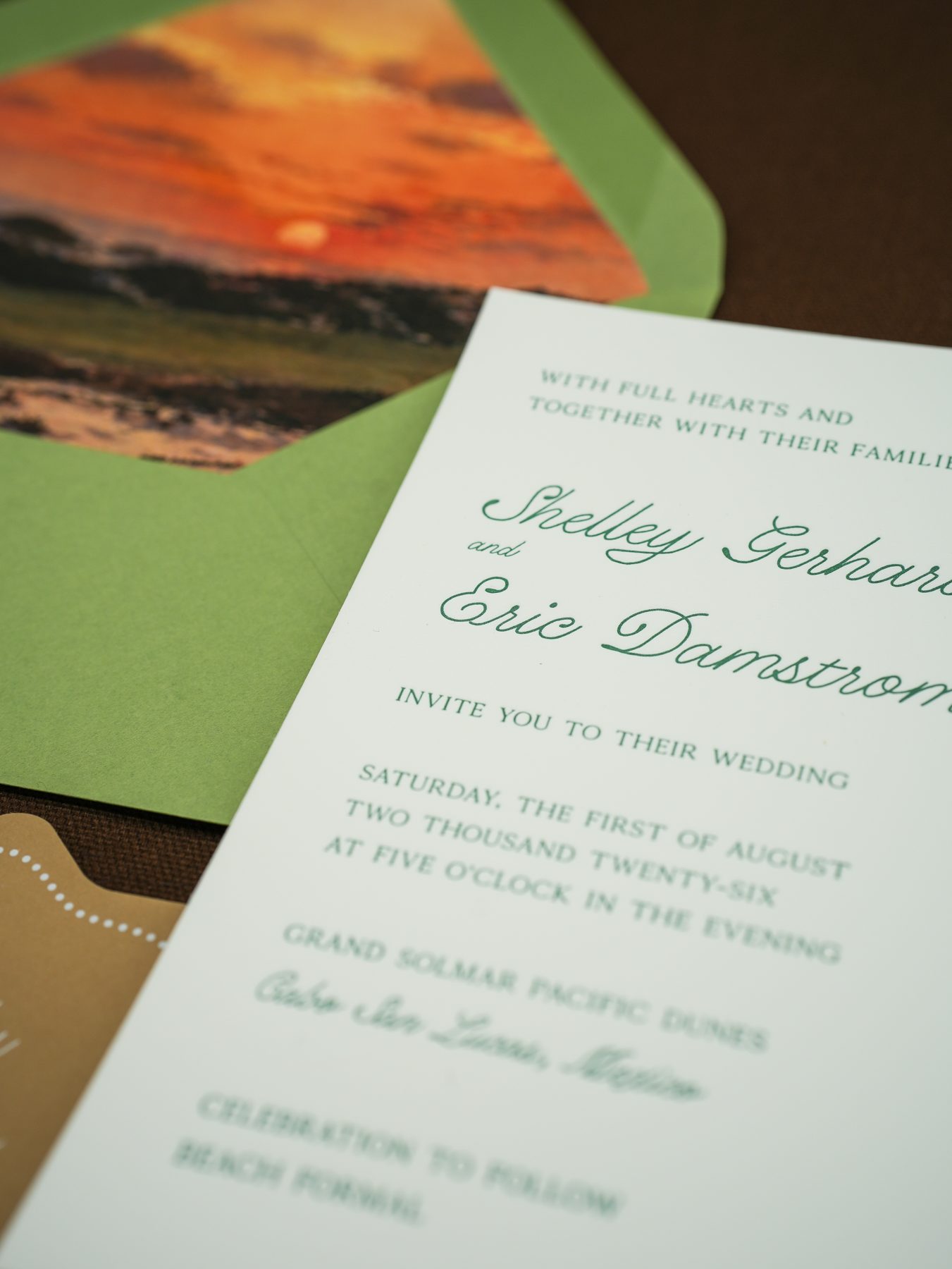 A coral floral wedding envelope dressed with vintage postage stamps and a watercolor envelope liner.
