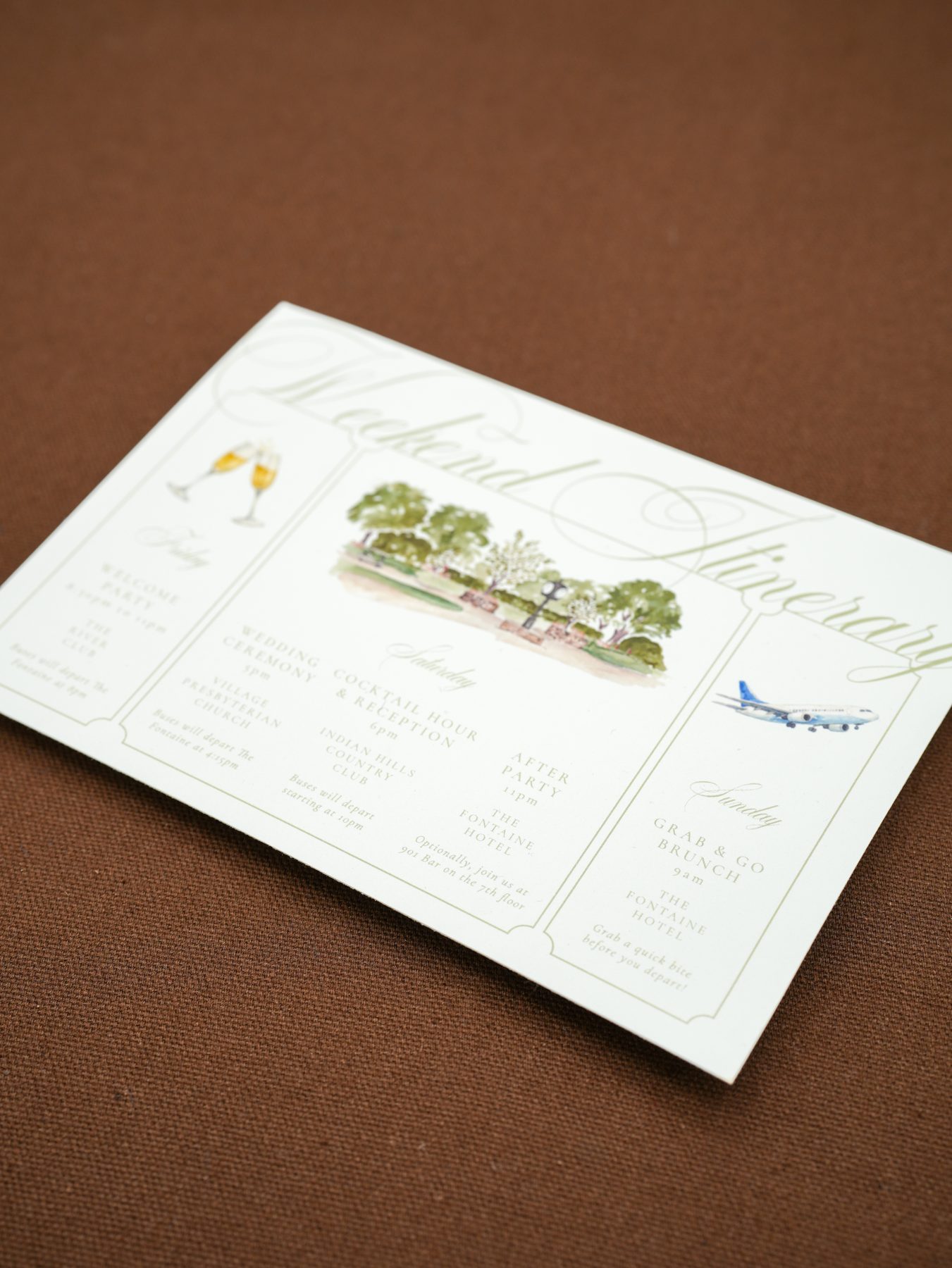 A watercolor sunset destination wedding invitation in soft sage and gold tones.