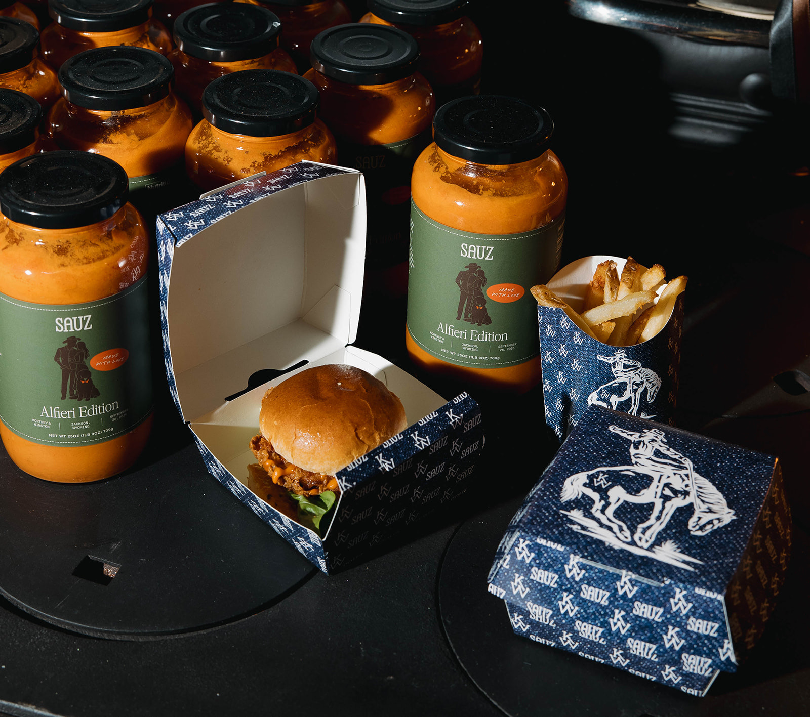 Late-night sliders and branded dipping-sauce bottles in blue western toile boxes.