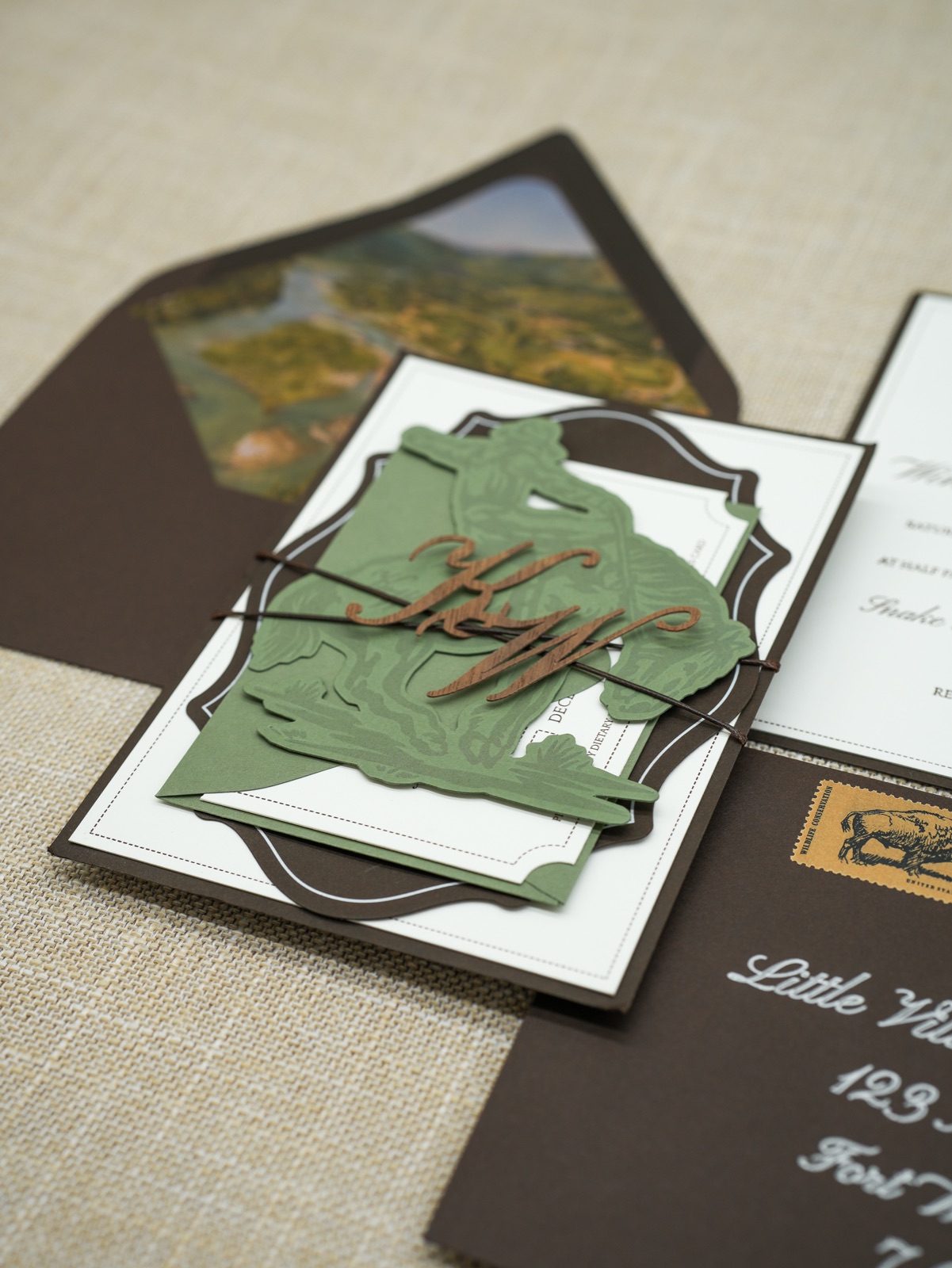 The bundled invitation over the valley-painted envelope liner.