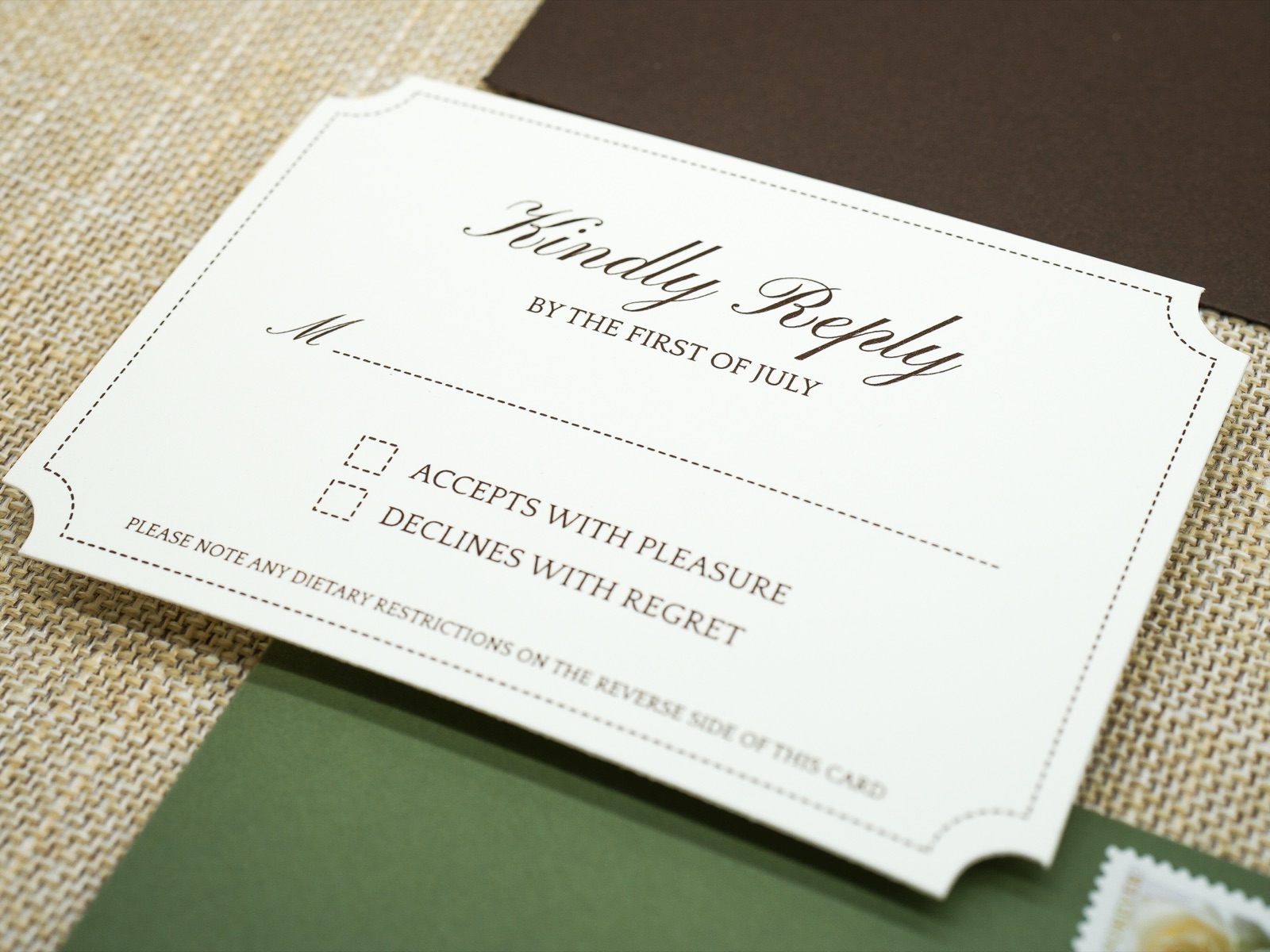 A letterpress reply card with scalloped corners in cream and chocolate brown.