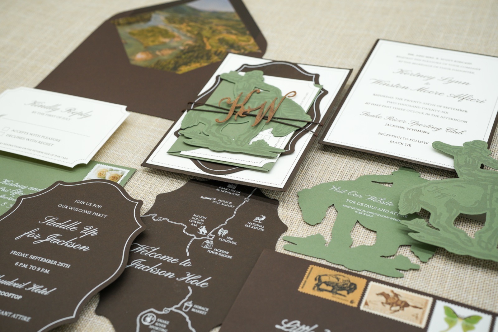 The suite gathered: reply card, weekend details cards, hand-drawn map, and vintage stamps.