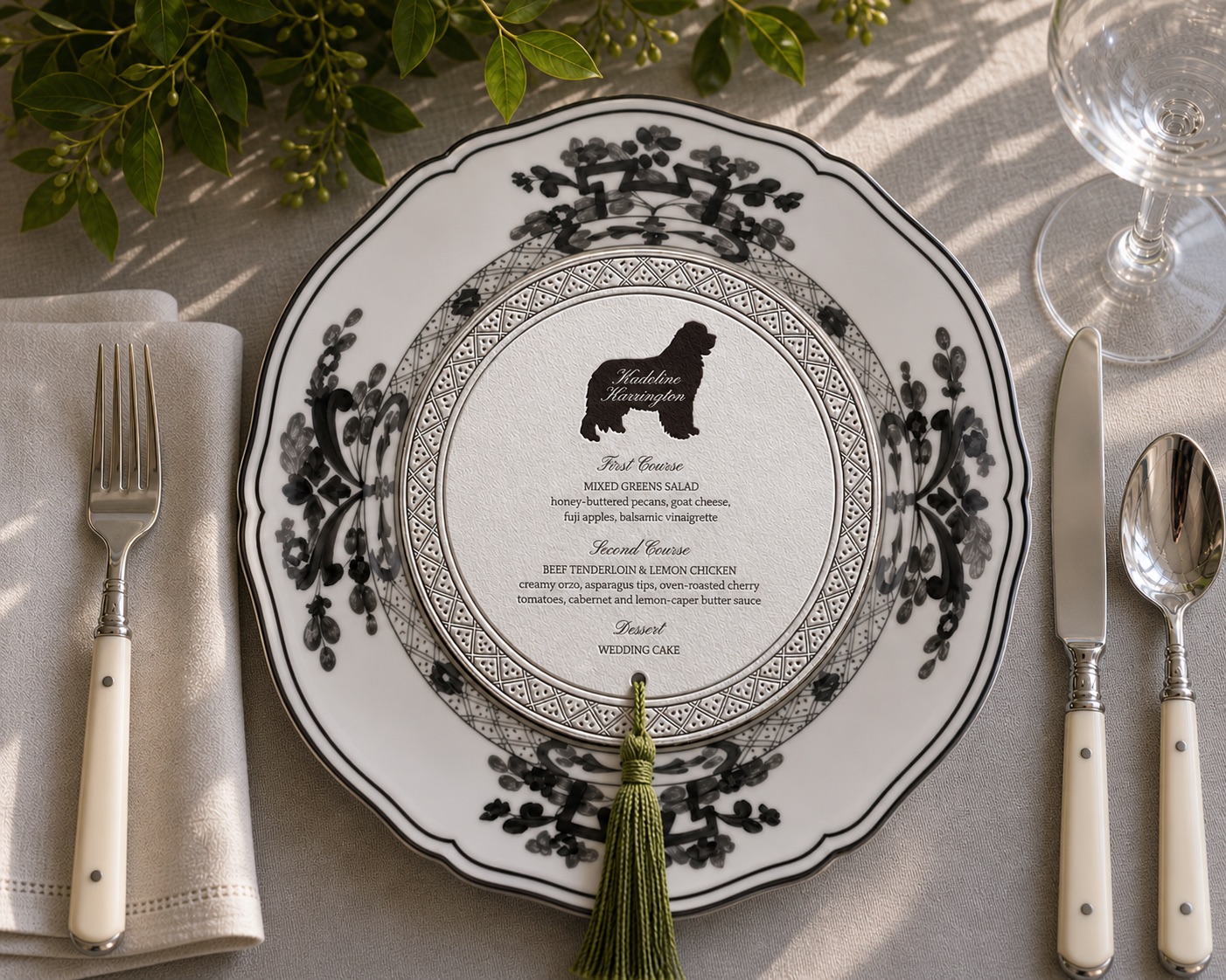 Custom die-cut wedding menu printed on a charger plate, with greenery and a tassel.