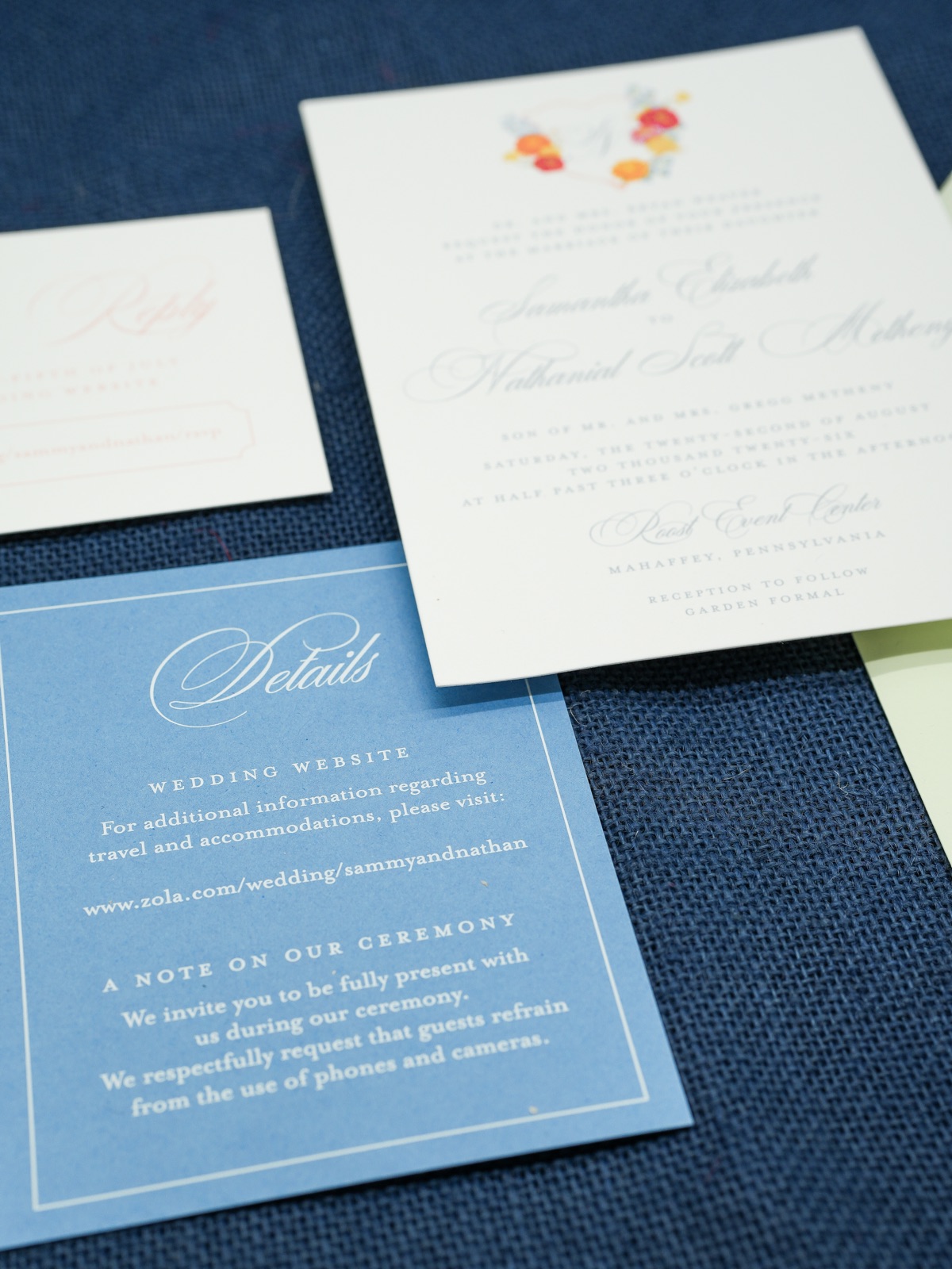 The invitation and French blue details card over the blush reply card.