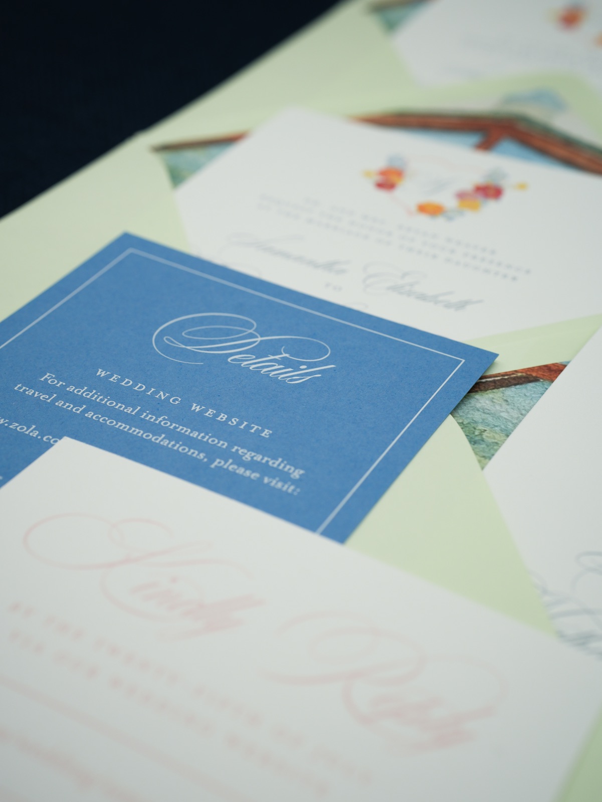 The French blue details card over the blush reply card.