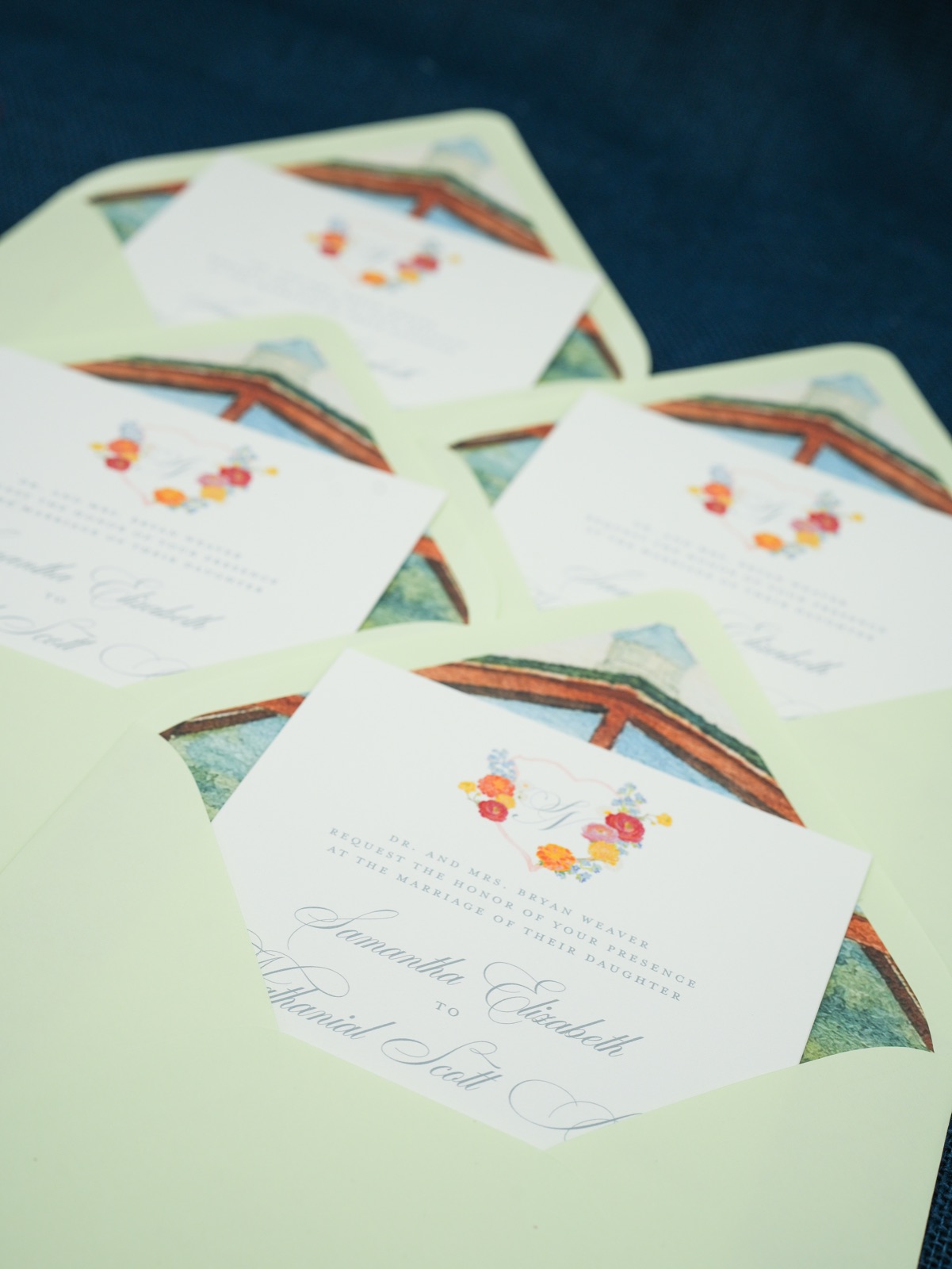 Chapel-lined envelopes and invitations spread across the table.