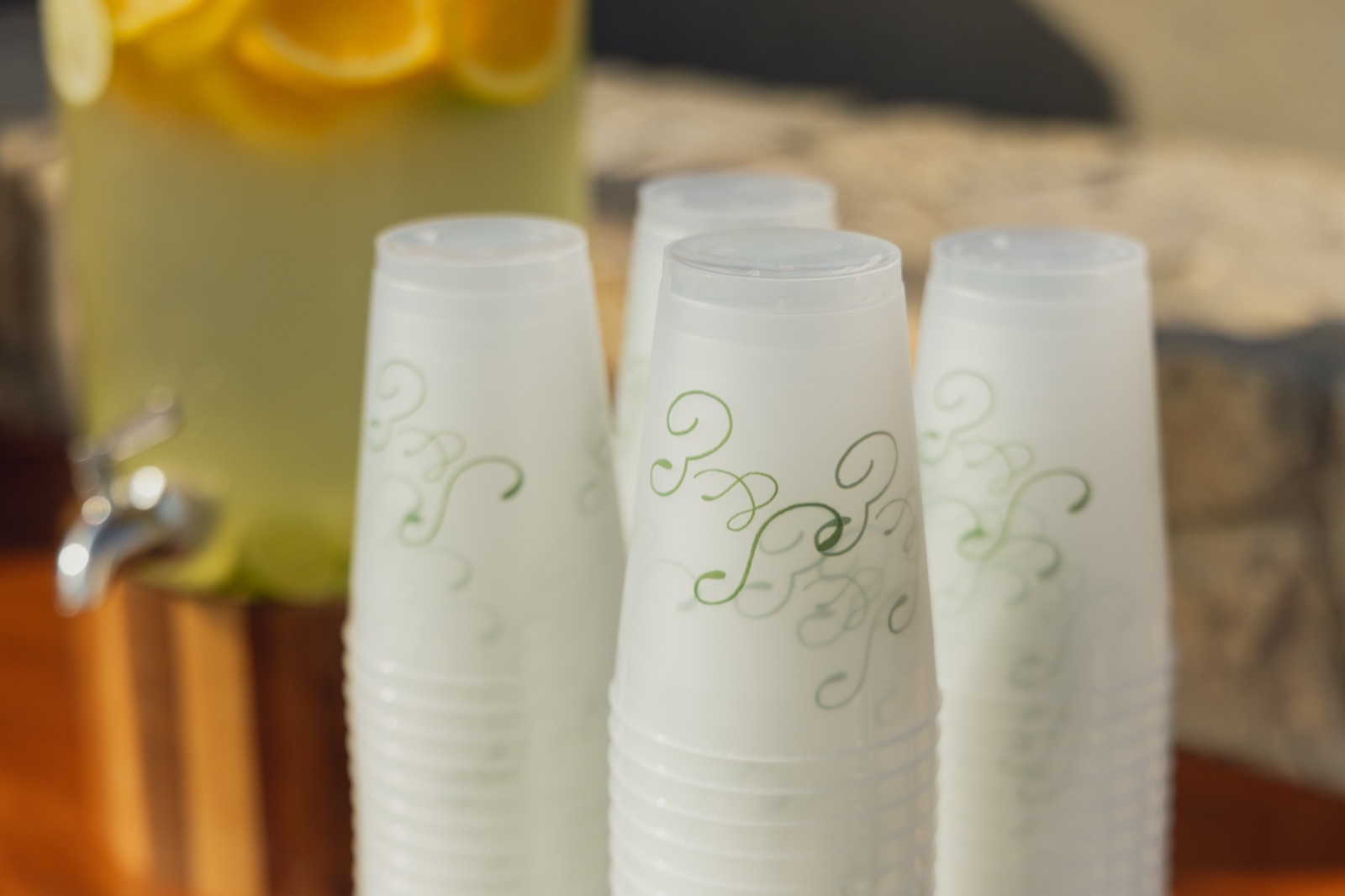 Monogrammed cups stacked beside fresh lemonade.