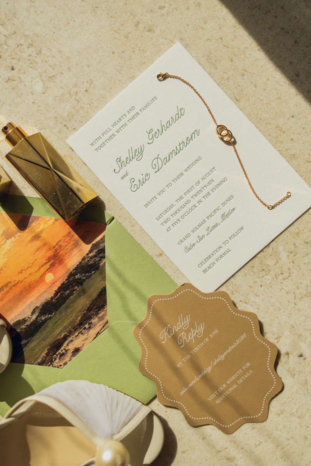The invitation over a sunset liner with the scalloped kraft tag.