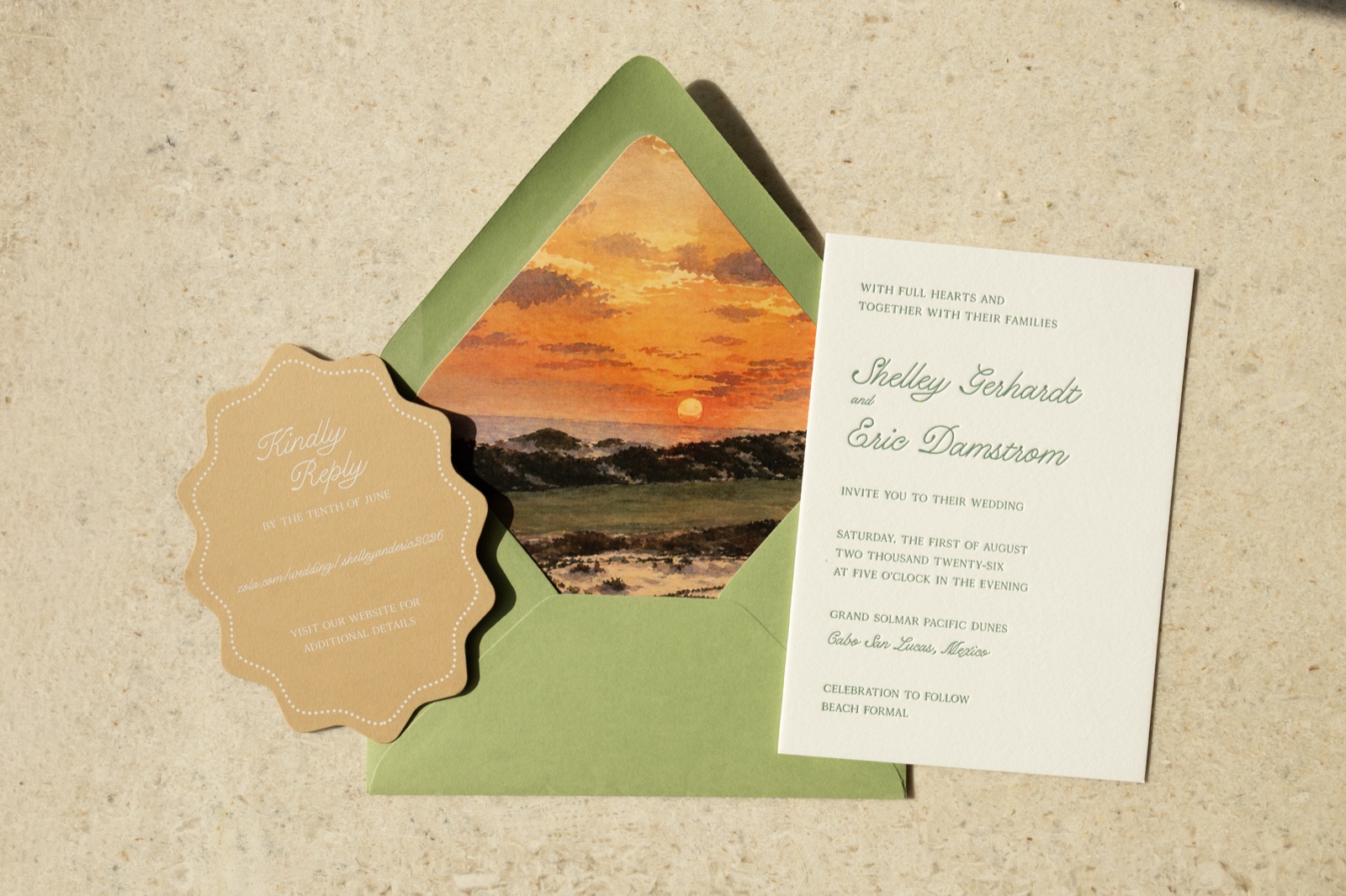 The invitation suite: letterpress card, scalloped kraft tag, and a sunset-painted envelope liner.